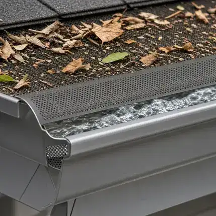 Close-up of a metal gutter edge with a protective guard